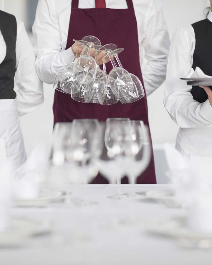 waiting-staff-in-restaurant-preparing-table-mid